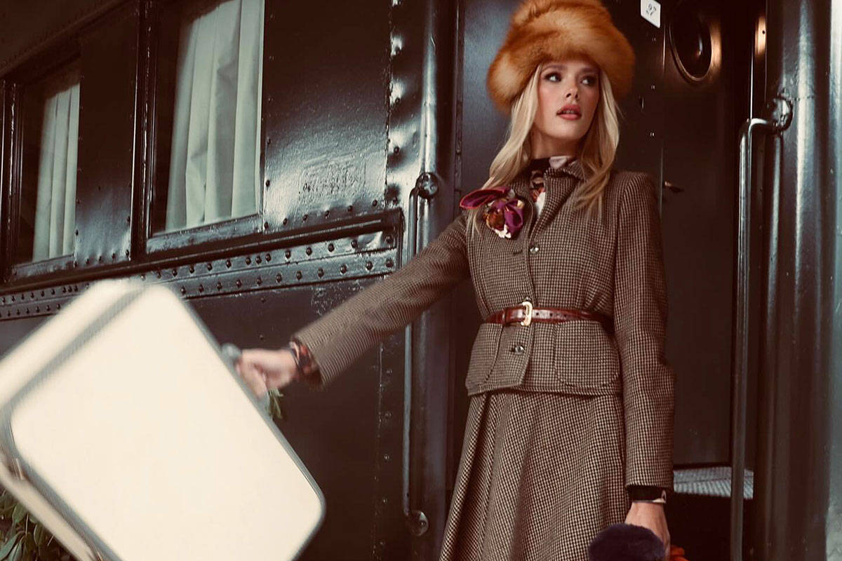 Girl with suitcase coming off train