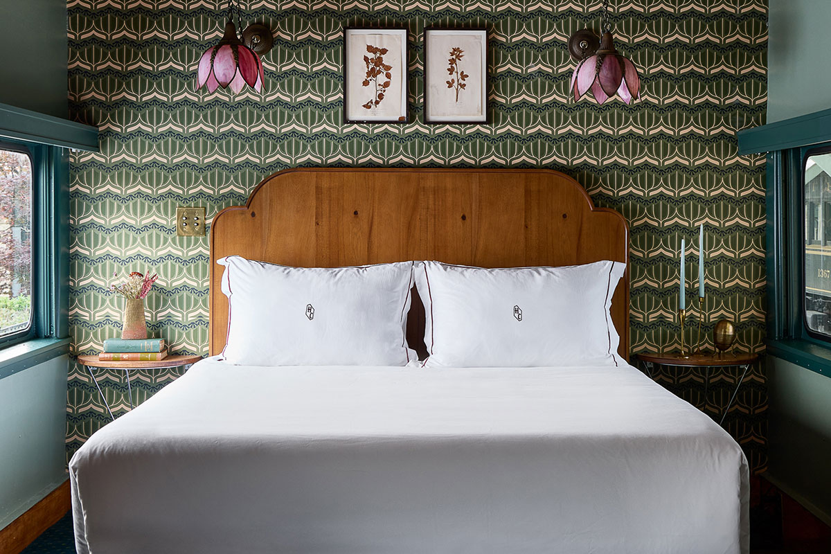 The Hotel Chalet bed with two purple flower sconces