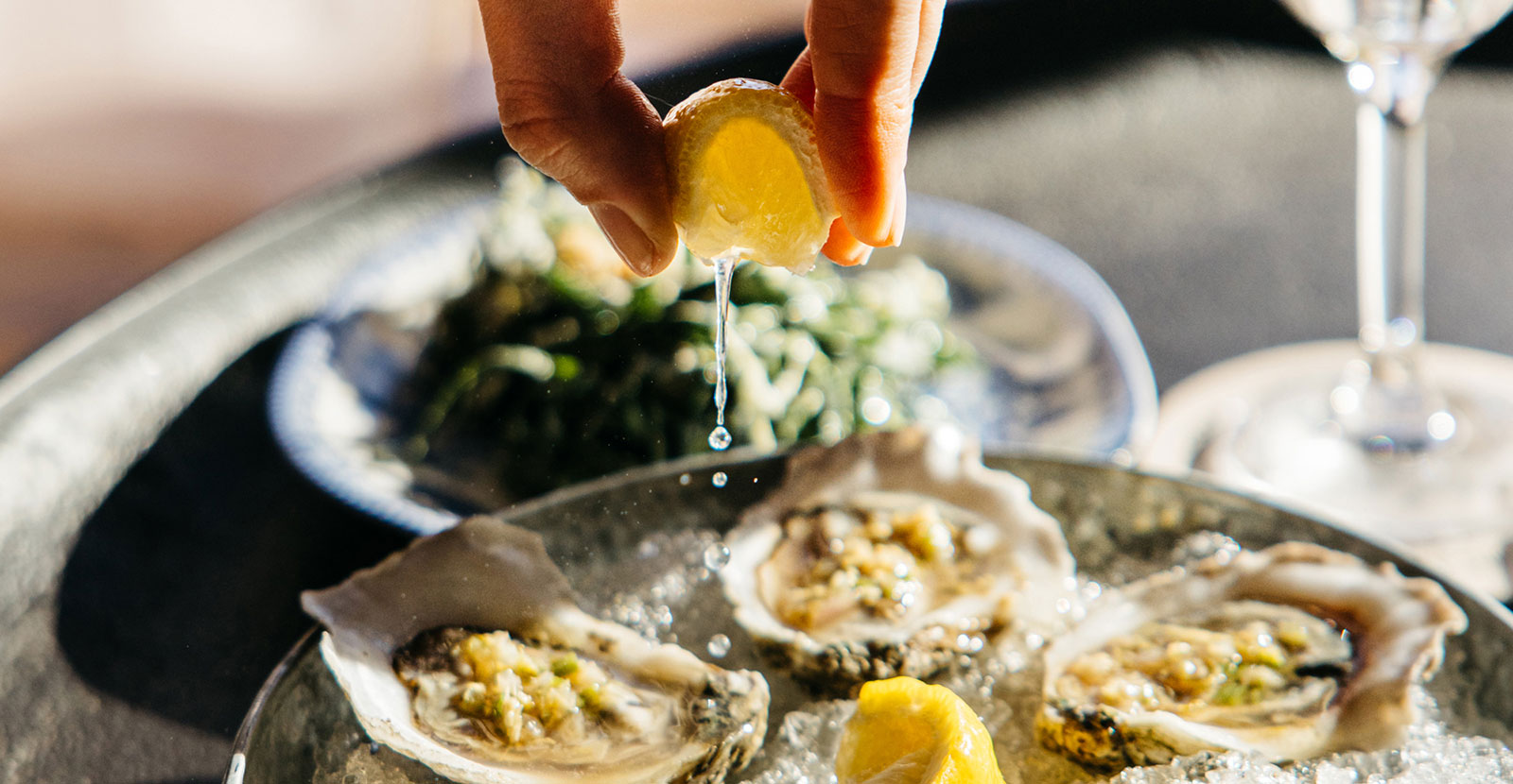Squeezing a lemon on a dish