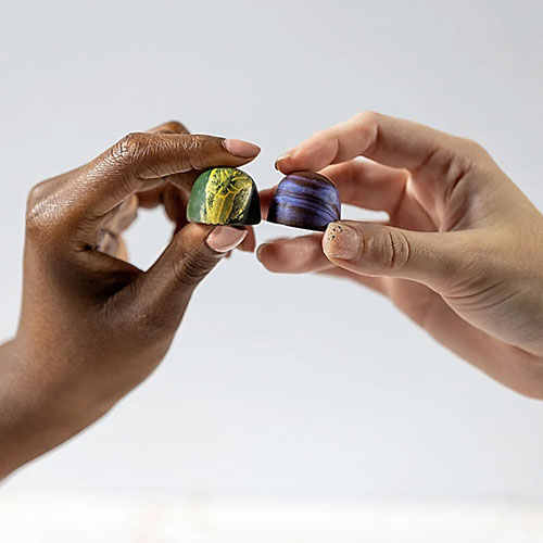 two hands holding chocolates