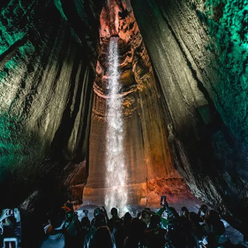 group looking at an underground waterfall